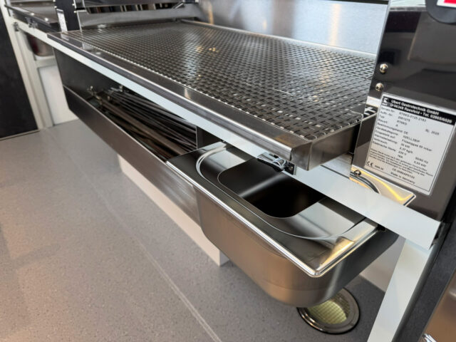Ausziehbare Arbeitsflächen und Fettwanne am Grill in einem Hähnchengrillmobil